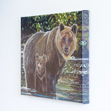 Load image into Gallery viewer, A side view of a canvas reproduction of a painting. The painting features two grizzly bears, a mother, and her young cub crossing a river. The image wraps around the edge of the canvas to reflect what is on the front, showing more water and background.

