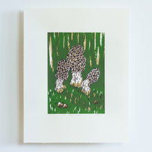 Load image into Gallery viewer, A small screenprint of three morel mushrooms on a dark green background. The print is made up of three colours, an emerald green, a light brown, and a dark brown. The print is small on the paper, with large white borders around it.
