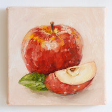 Load image into Gallery viewer, A small oil painting of an apple. The large, shiny apple is bright red on a peach coloured background. There is a slice of apple in the foreground with a green apple leaf to the left of it.
