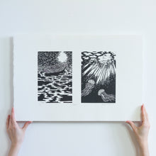 Load image into Gallery viewer, Two hands holding a black and white linocut print from the bottom. There are two images, the first of a boat sitting on the water at nighttime, reflecting the light of the moon. The second is of the light illuminating two jellyfish underneath the water.

