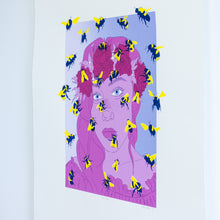 Load image into Gallery viewer, A side angled view of a screenprint of a woman’s face surrounded by buzzing bees. The woman is printed in shades of pink and is wearing a flower crown. Dozens of navy blue and yellow bees fly around her face, some extending outside the frame of the image.
