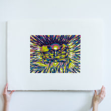 Load image into Gallery viewer, Two hands holding a woodblock print of 3 faces from the bottom. The faces are made up of the colours purple, blue, green, and pink. They are attached together with stretched out strands. Chaotic lines extend from the faces to the outside of the image.

